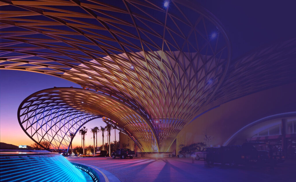 Front entrance of casino with several vehicles parked.